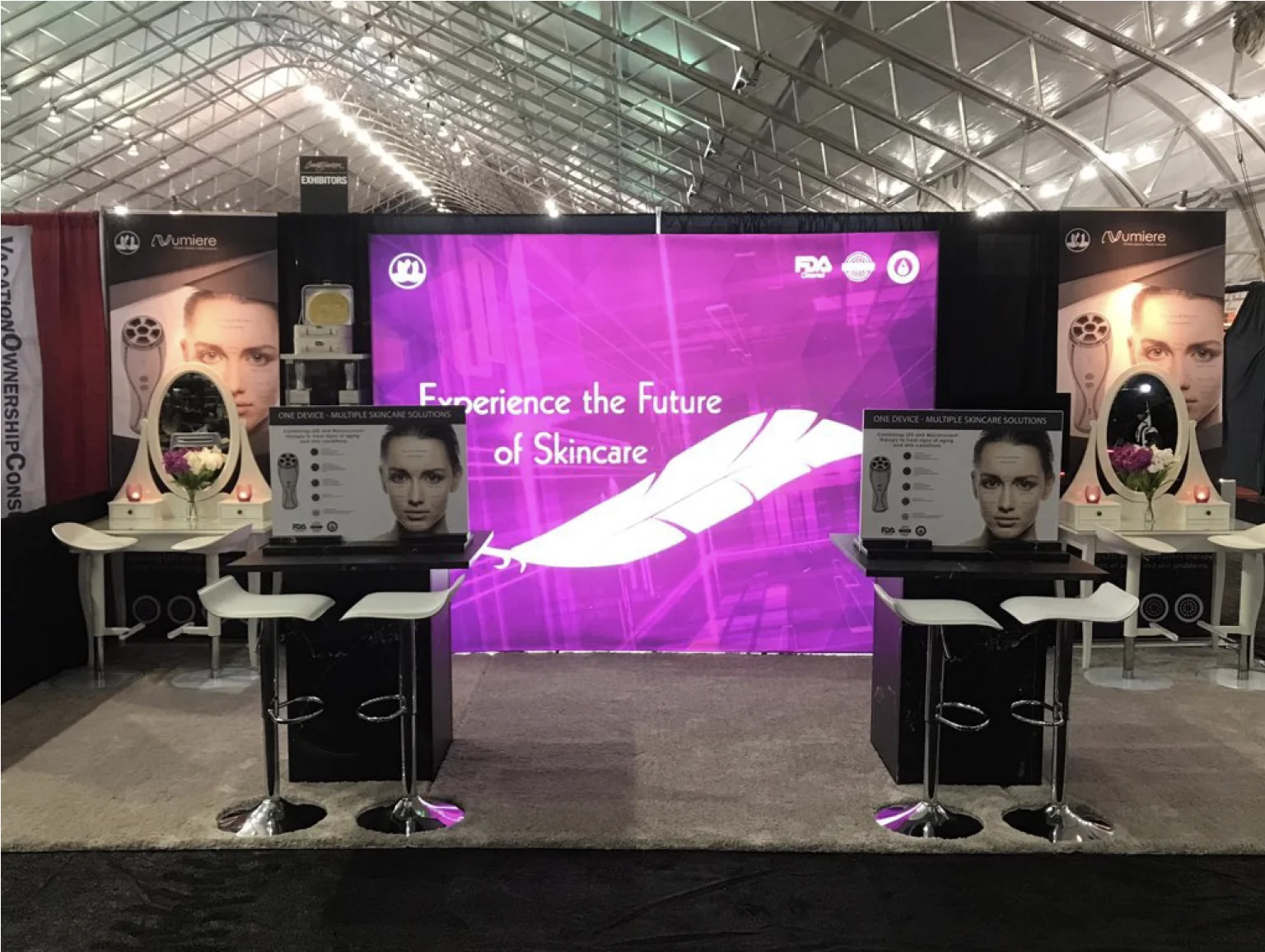 Compact demonstration space with two seated counters and a colorful backlit wall
