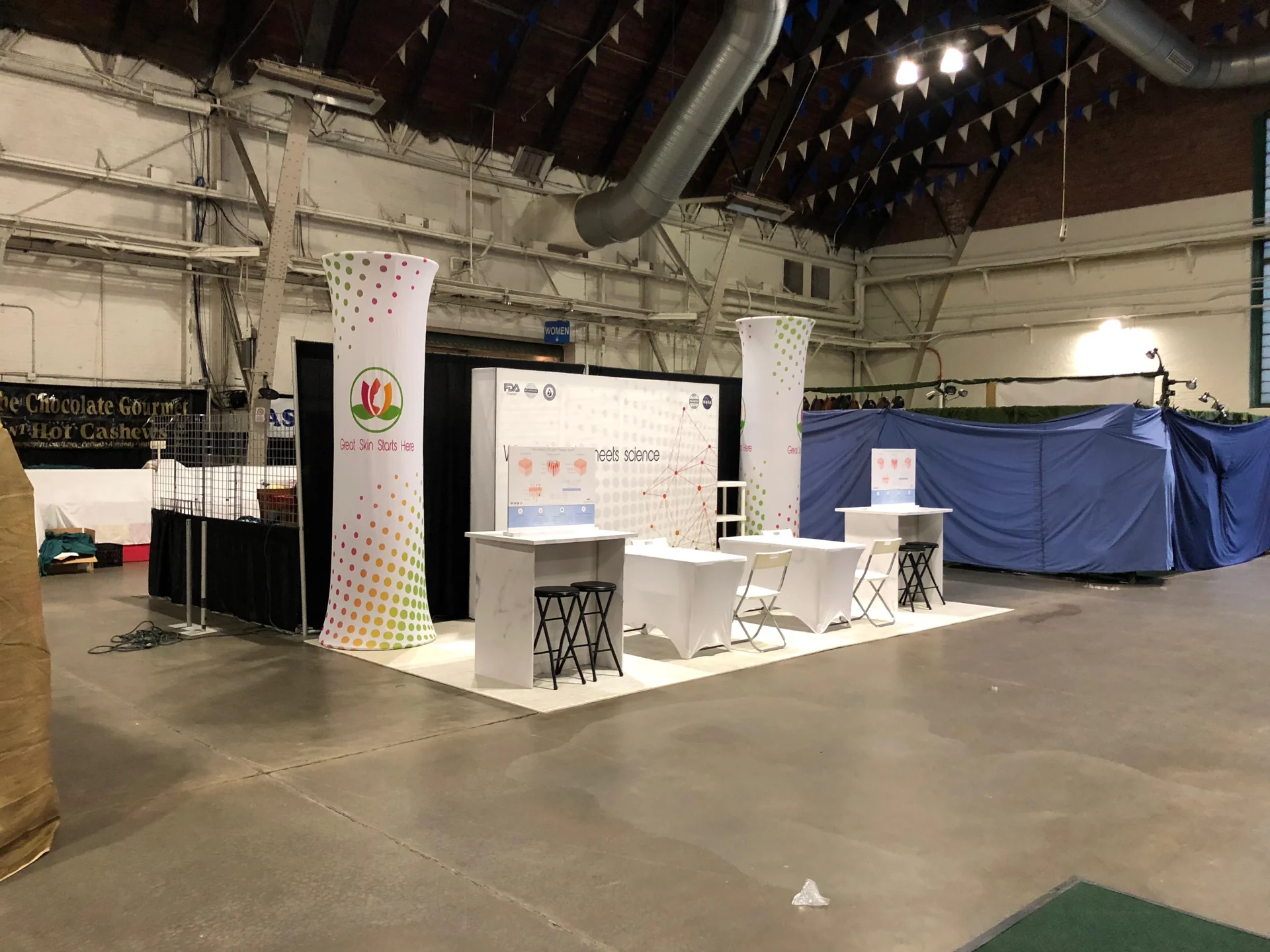 Open-front Mazel exhibit with white demonstration counters