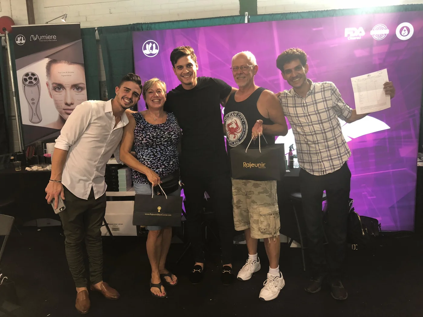 Mazel team members and visitors together at a Numiere exhibition booth